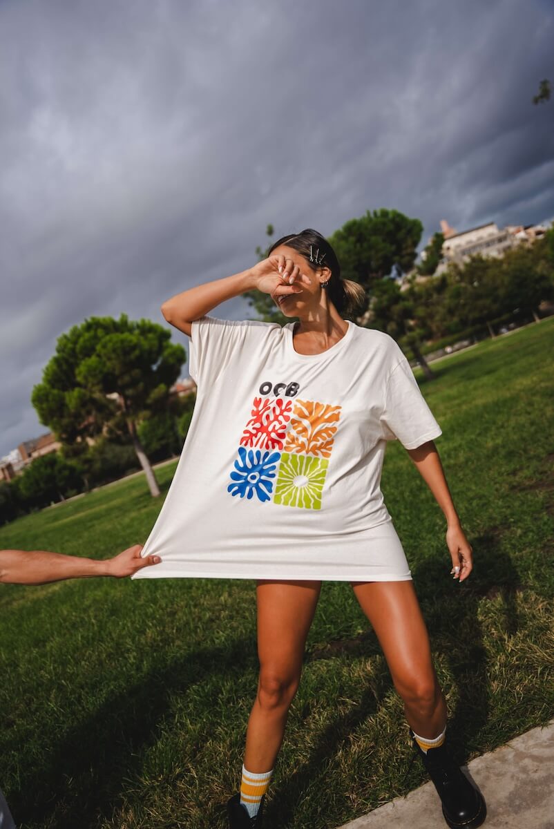 Woman wearing a white t-shirt with colorful design outdoors